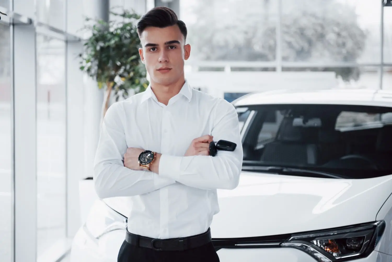 First-time hybrid car buyer learning tips about battery longevity at dealership.