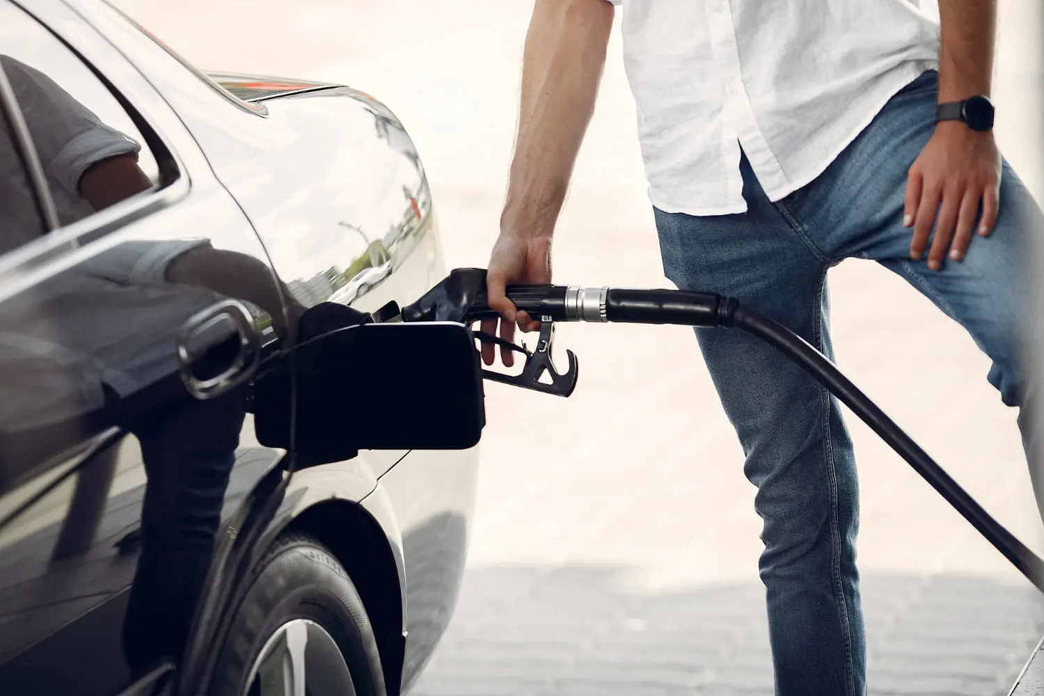 Refueling a car at the pump illustrates tips to boost daily commute fuel economy