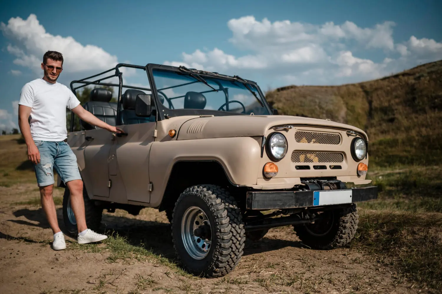 Owner beside an off-road vehicle, weighing trail capability versus daily mileage
