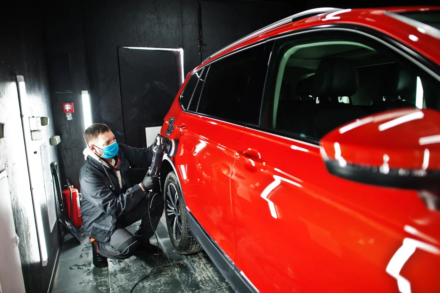 Technician applying paint protection to a car, ceramic coating vs PPF durability
