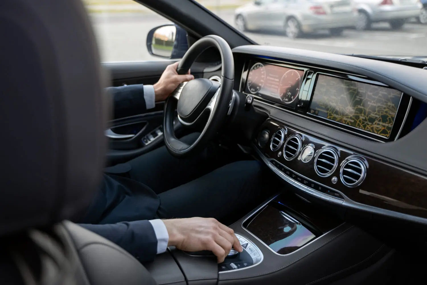 Driver inside a quiet luxury SUV cabin during a road noise comparison test drive